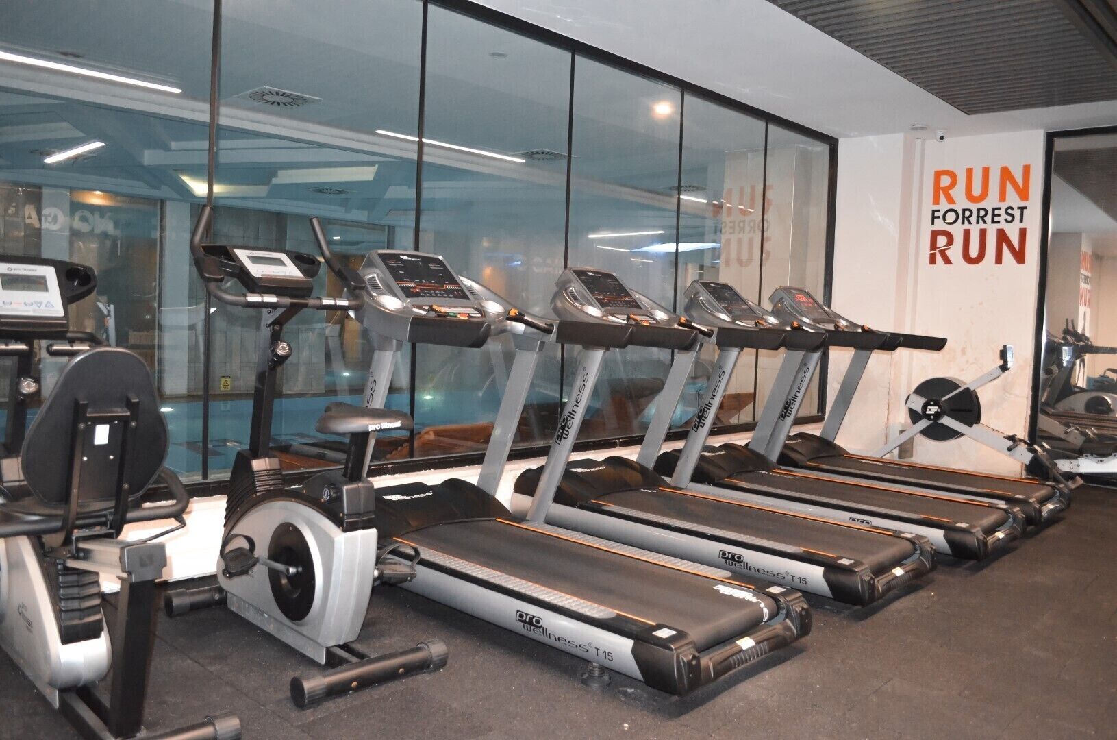 A gym with multiple treadmills, stationary bikes, and weight machines.
