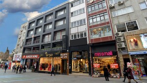 A multi-story building with various shops including Burger King, Missmali, and a suit store. - Palmiye Suit (Istanbul)