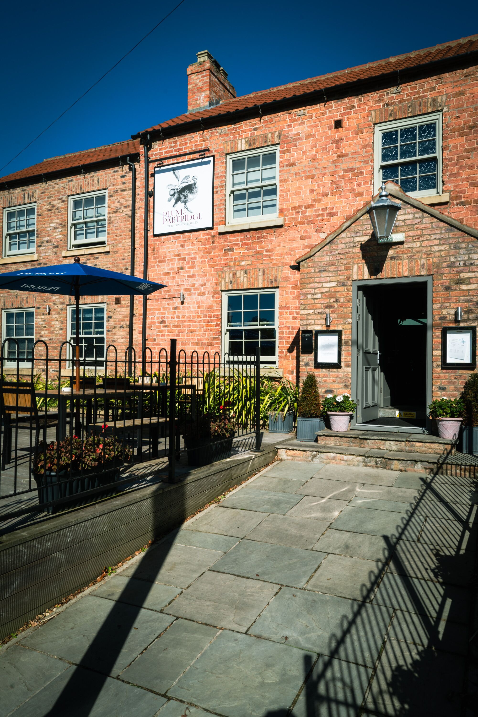 A brick building with a sign reading "Plum Partridge."