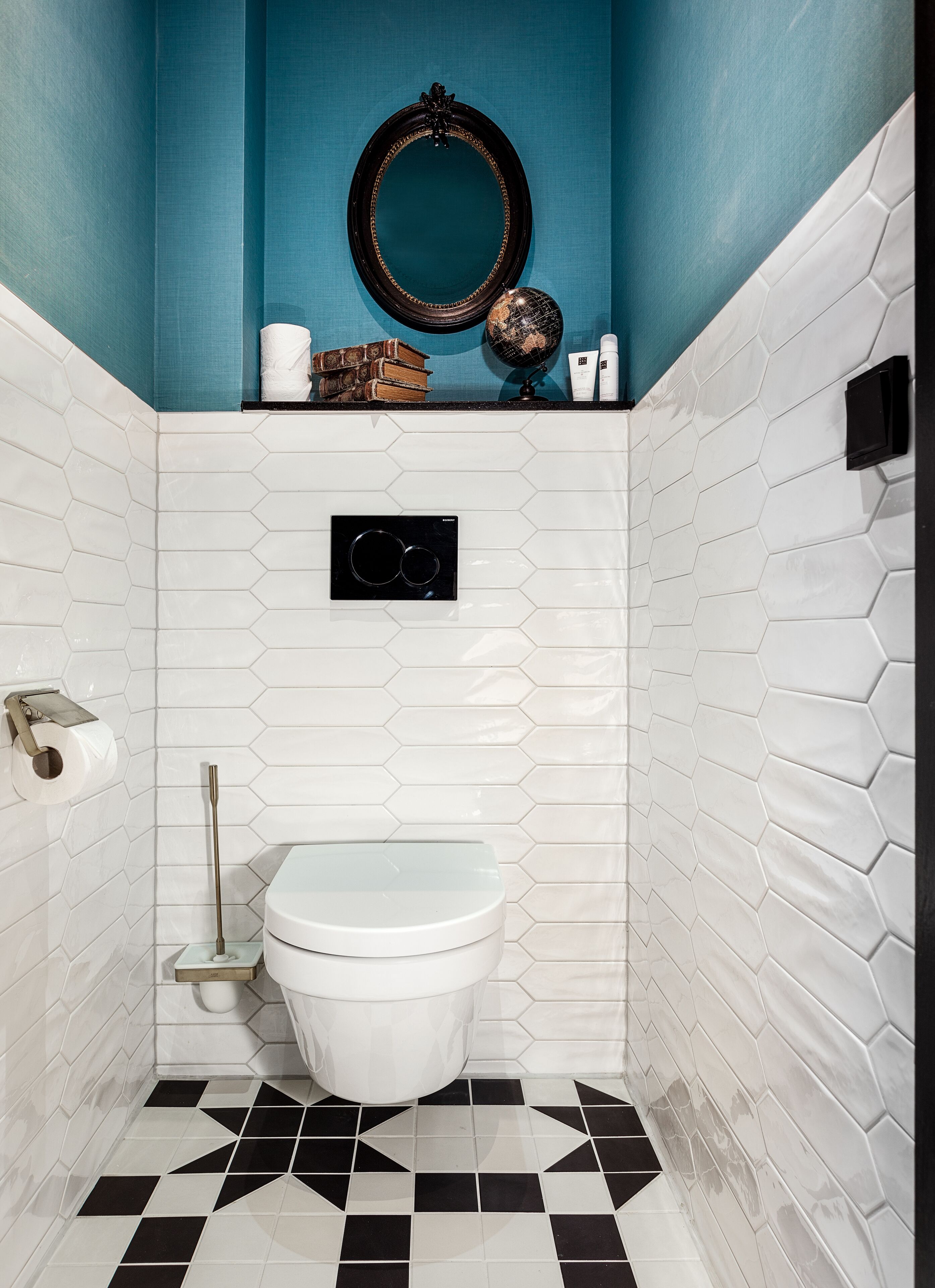 A bathroom with a white toilet, a black and white checkered floor, and a blue wall.