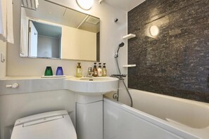 Combined shower/tub, free toiletries, hair dryer, slippers