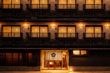 A traditional building with multiple windows and balconies, featuring a sign with the name 'AKARI' at the entrance.