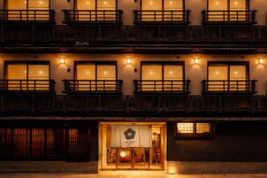 Un edificio tradicional con varias ventanas y balcones, que presenta un letrero con el nombre 'AKARI' en la entrada.