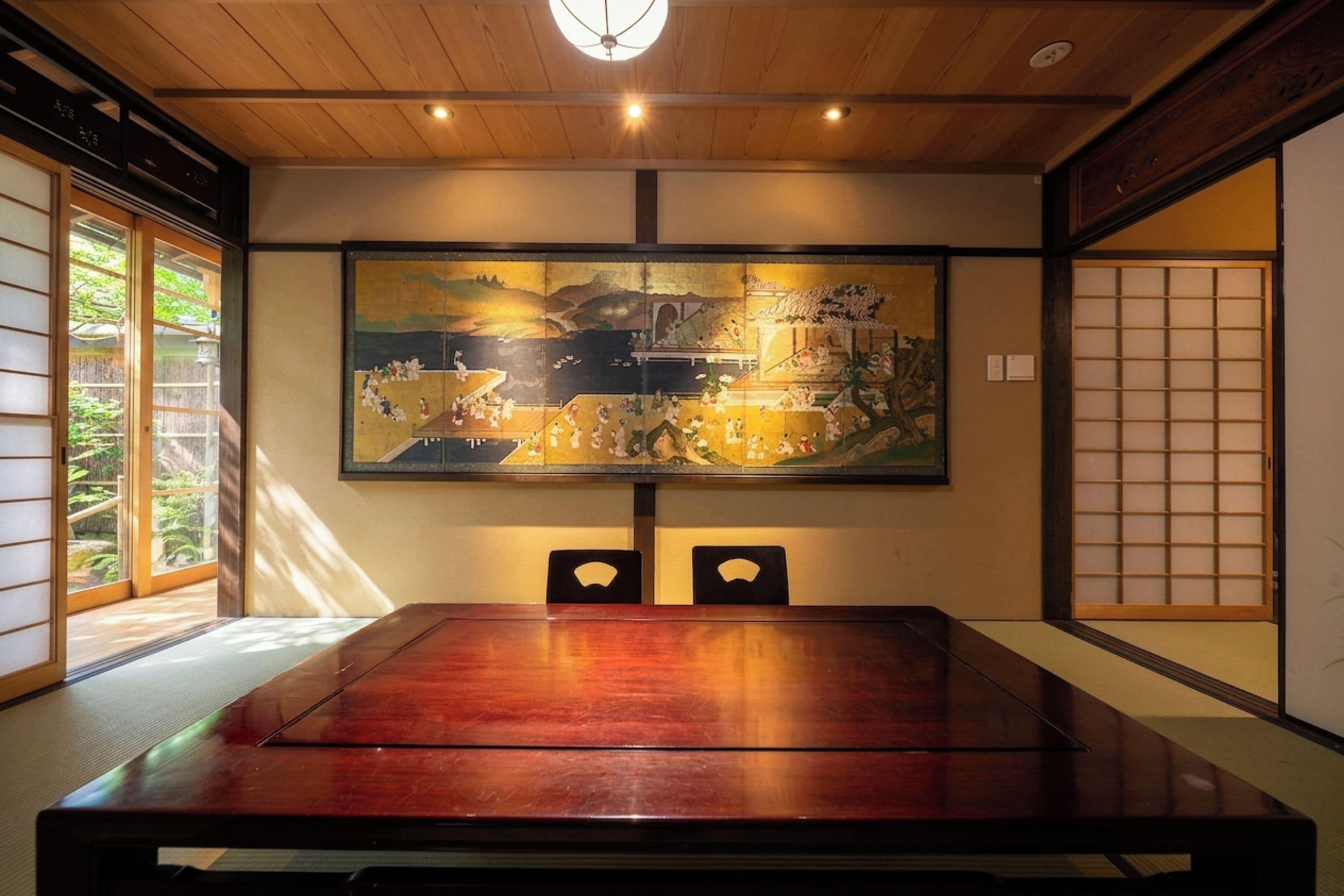 A traditional Japanese room with tatami flooring, a low wooden table, and a large painting on the wall.