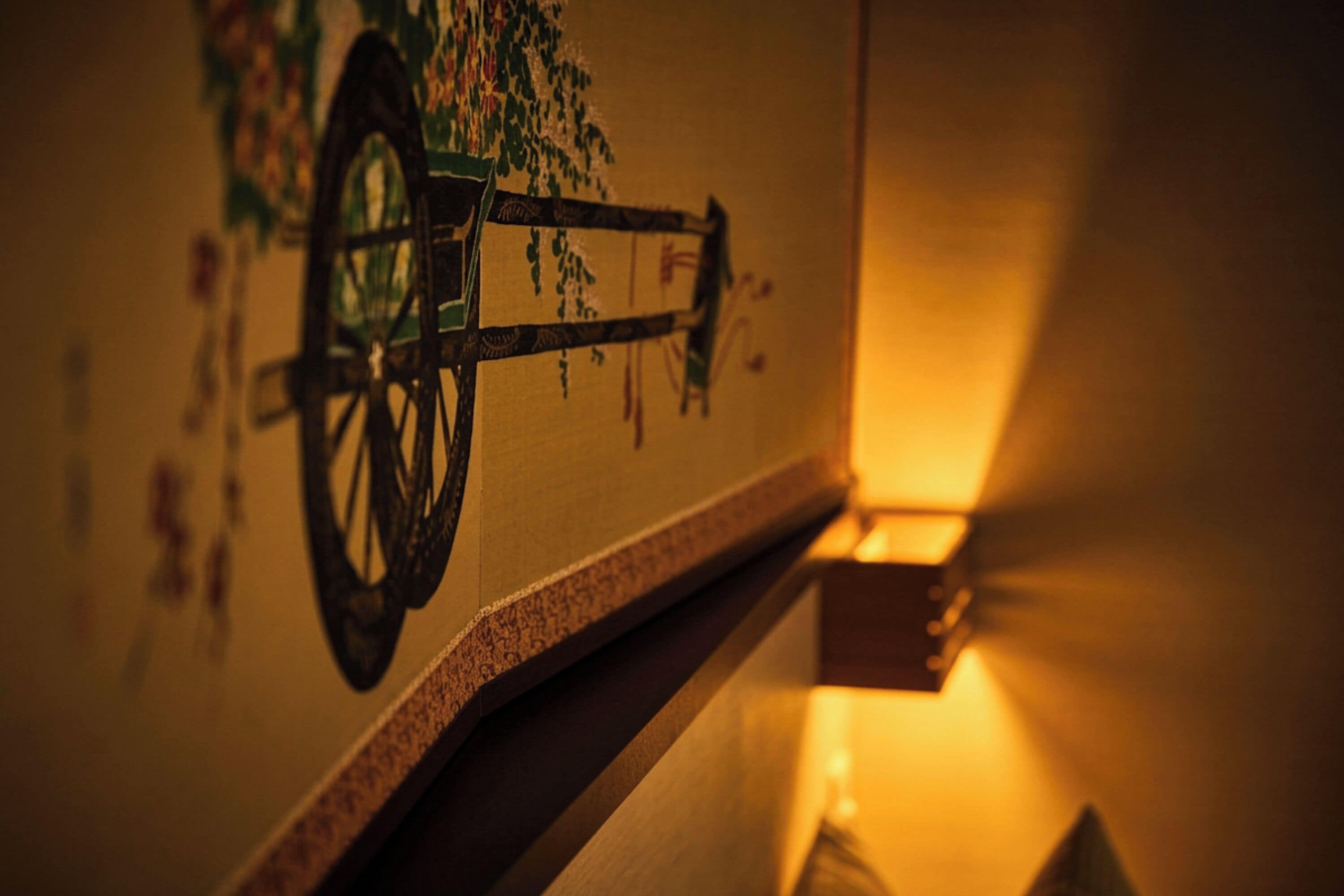 A staircase with a wall-mounted artwork featuring a bicycle.