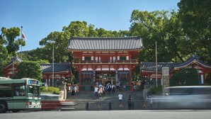A traditional Japanese building with a prominent entrance, steps leading up to it, and a clear sky in the background. - AKARI Kyoto Gion (Kyoto)