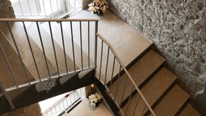 A stone-walled staircase with a metal railing, leading to a lower level. - GRAFFITI LIVING-SANTA RITA (Corato)