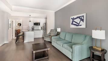 A modern living room with a sofa, coffee table, and a lamp.