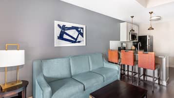 1 Bedroom 1 King Deluxe Suite with Sofabed | Living area | 50-inch LCD TV with cable channels