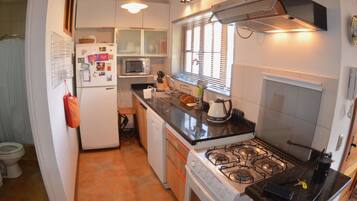 Standard Apartment, 2 Bedrooms, Partial Sea View, Ground Floor | Private kitchen | Full-sized fridge, microwave, oven, stovetop