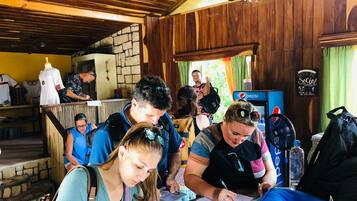 Um grupo de pessoas sentadas à mesa, escrevendo ou assinando documentos.
