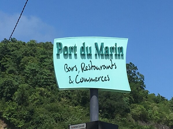 A sign for Port du Marin advertising bars, restaurants, and commerce.
