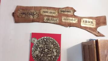 A wooden plaque with grain labels and a circular metal plaque with text.