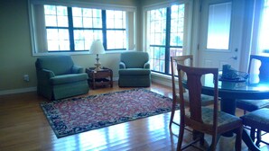 A living room with two armchairs, a wooden chair, a small table, and a patterned rug. - Family Friendly Lakefront House on Greers Ferry Lake 1/2 mile to Marina, Boating (Clinton)