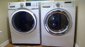 Two front-loading washing machines in a laundry room. - Family Friendly Lakefront House on Greers Ferry Lake 1/2 mile to Marina, Boating (Clinton)