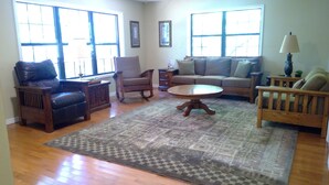 A living room with a sofa, armchairs, a coffee table, and a rug. - Family Friendly Lakefront House on Greers Ferry Lake 1/2 mile to Marina, Boating (Clinton)