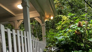 A garden with vibrant pink flowers and a white picket fence.