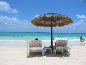 Ligstoelen aan het strand, parasols, strandlakens
