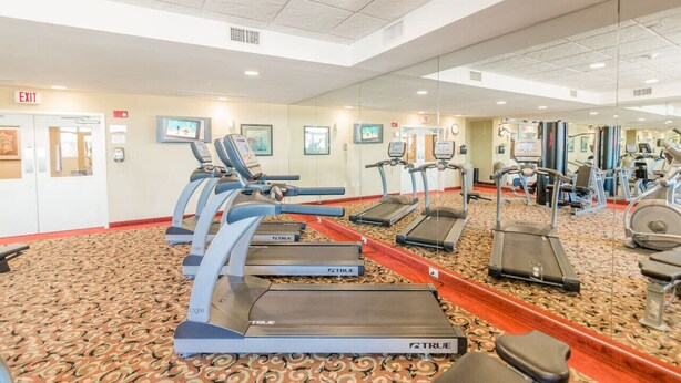 A gym with multiple treadmills, exercise bikes, and a mirrored wall. - 4BR/3BA, Sleeps 16, Large Oceanfront, Balcony (Myrtle Beach)
