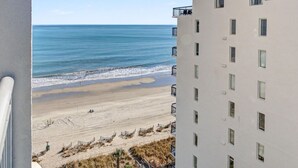 A beachfront hotel with multiple floors, balconies, and a view of the ocean. - 4BR/3BA, Sleeps 16, Large Oceanfront, Balcony (Myrtle Beach)