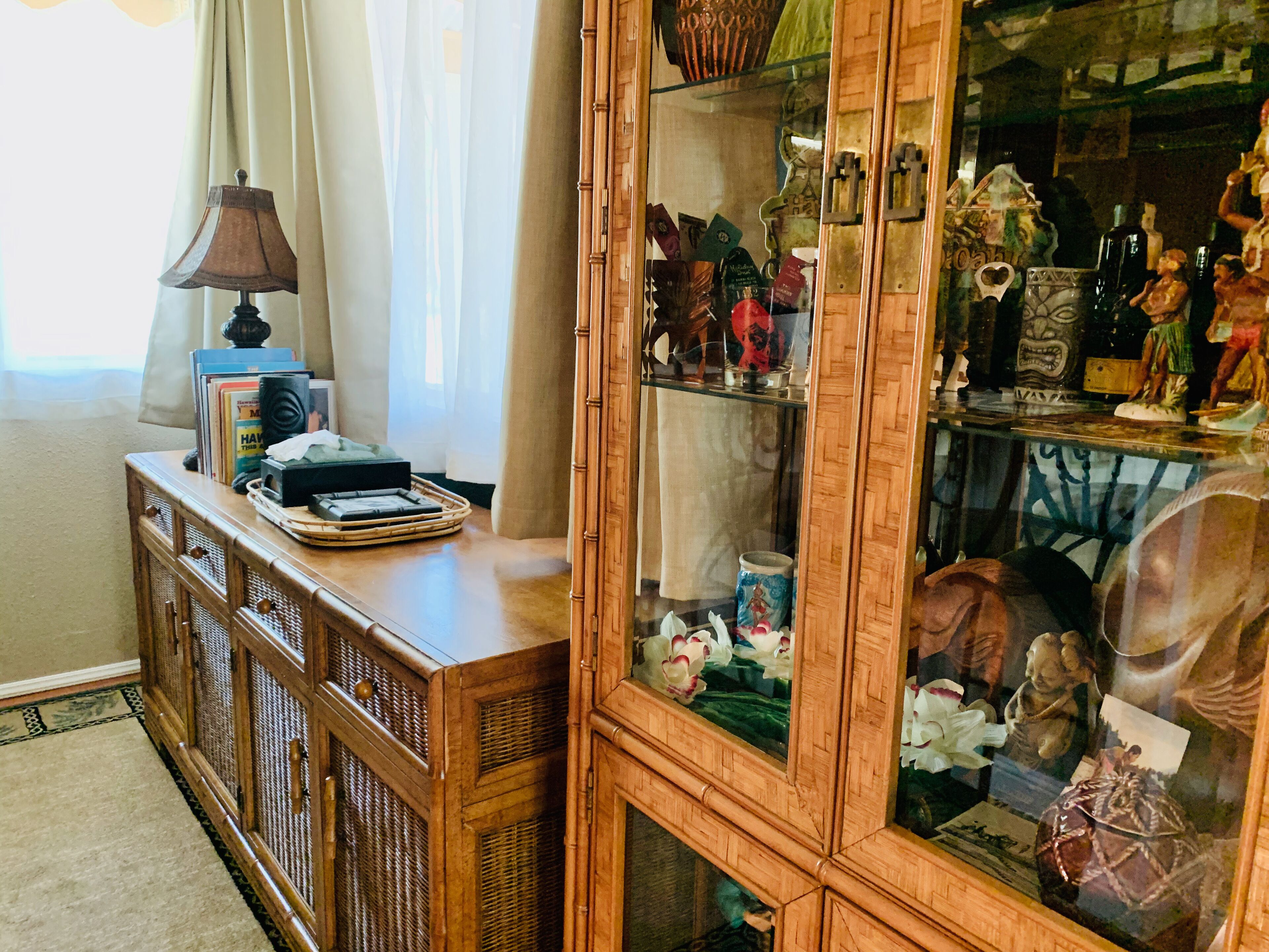 A wooden cabinet with glass doors displaying various items.
