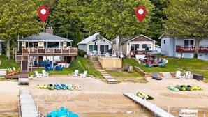 A waterfront property with a dock, kayaks, and a covered deck area. - Last Open Summer Weekend! August 29th - 31st (Twin Lake)