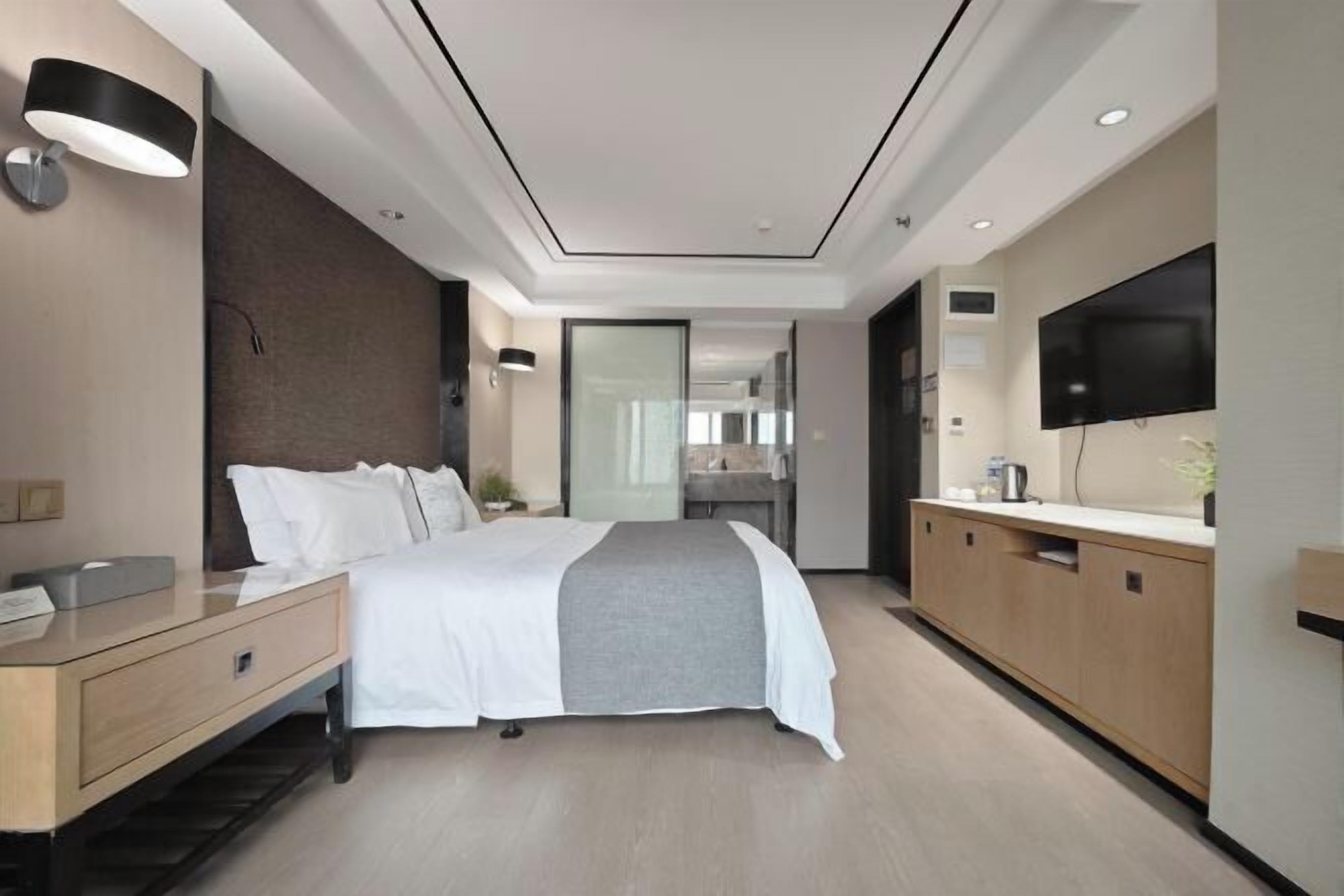 Premium bedding, desk, laptop workspace, blackout drapes