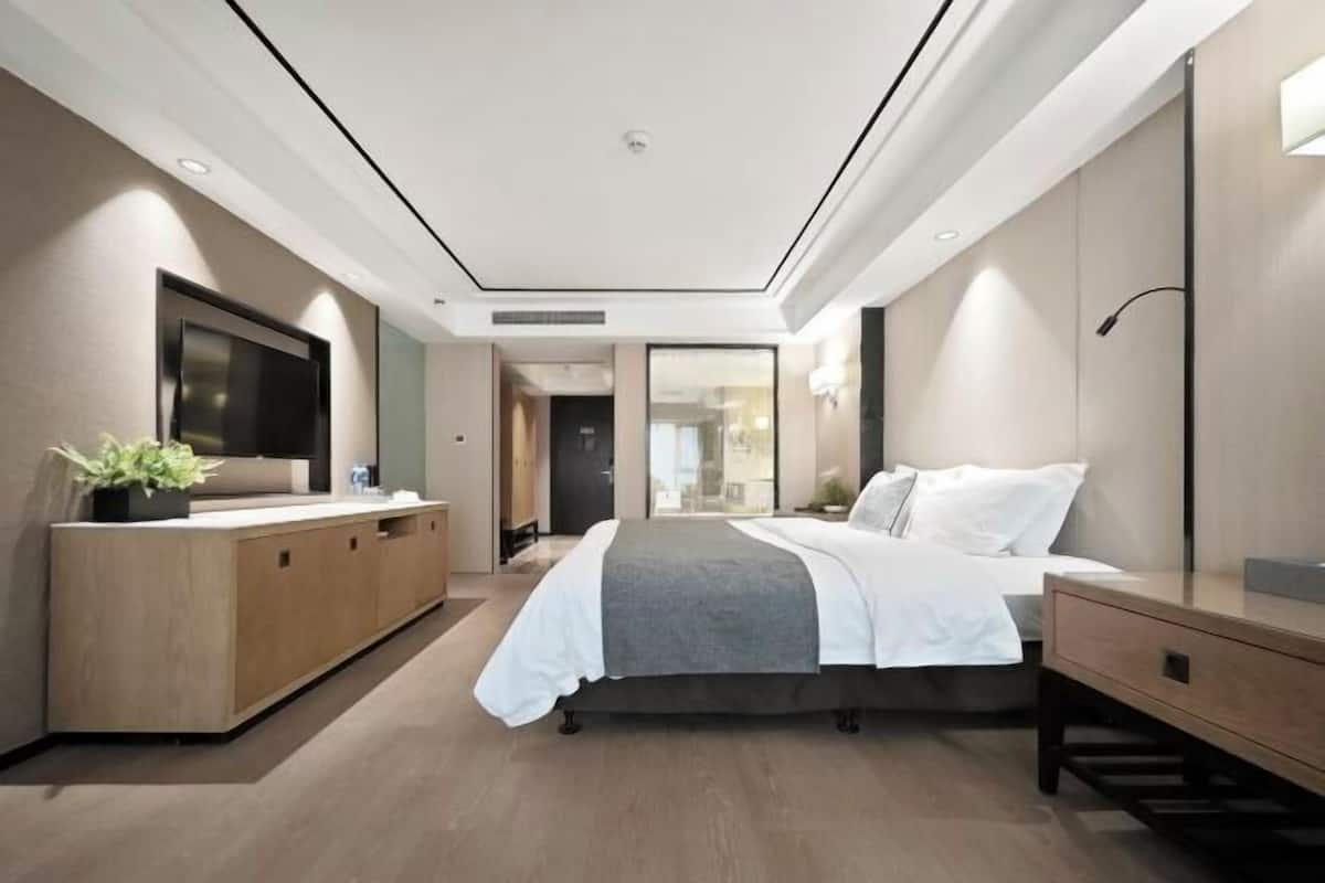 Premium bedding, desk, laptop workspace, blackout drapes