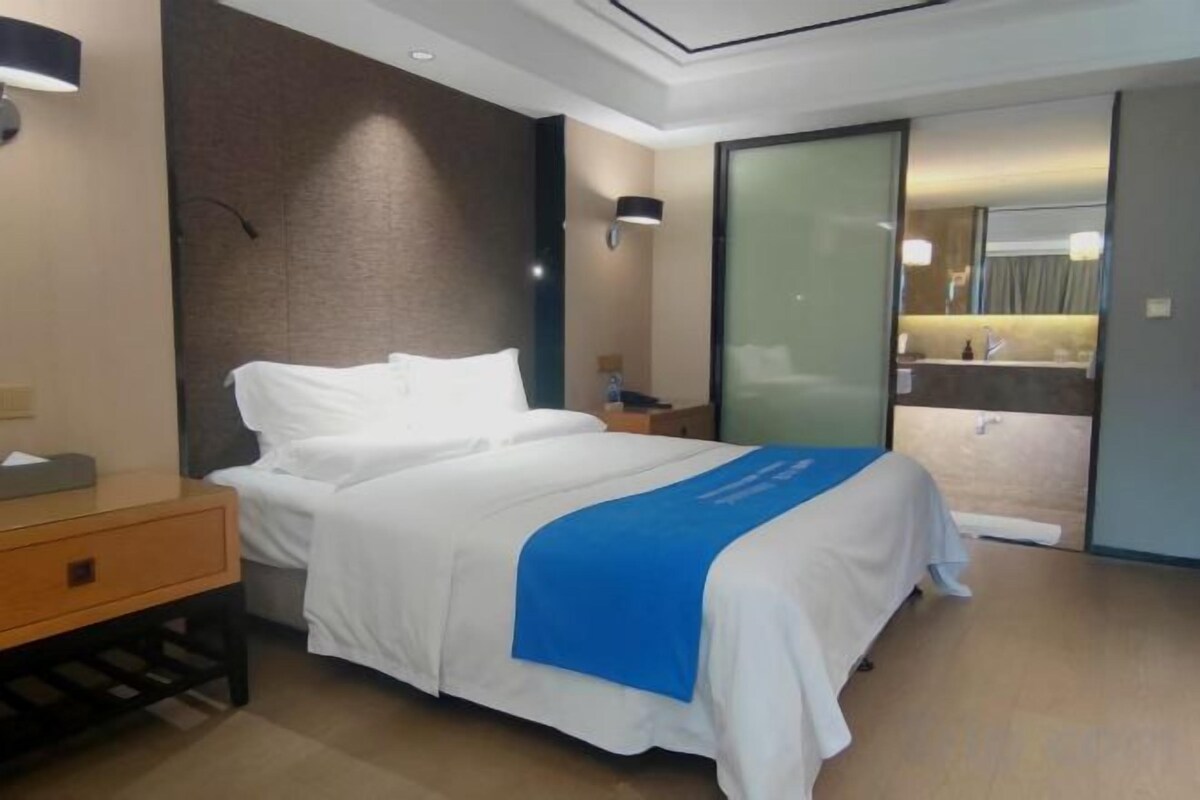 Premium bedding, desk, laptop workspace, blackout drapes