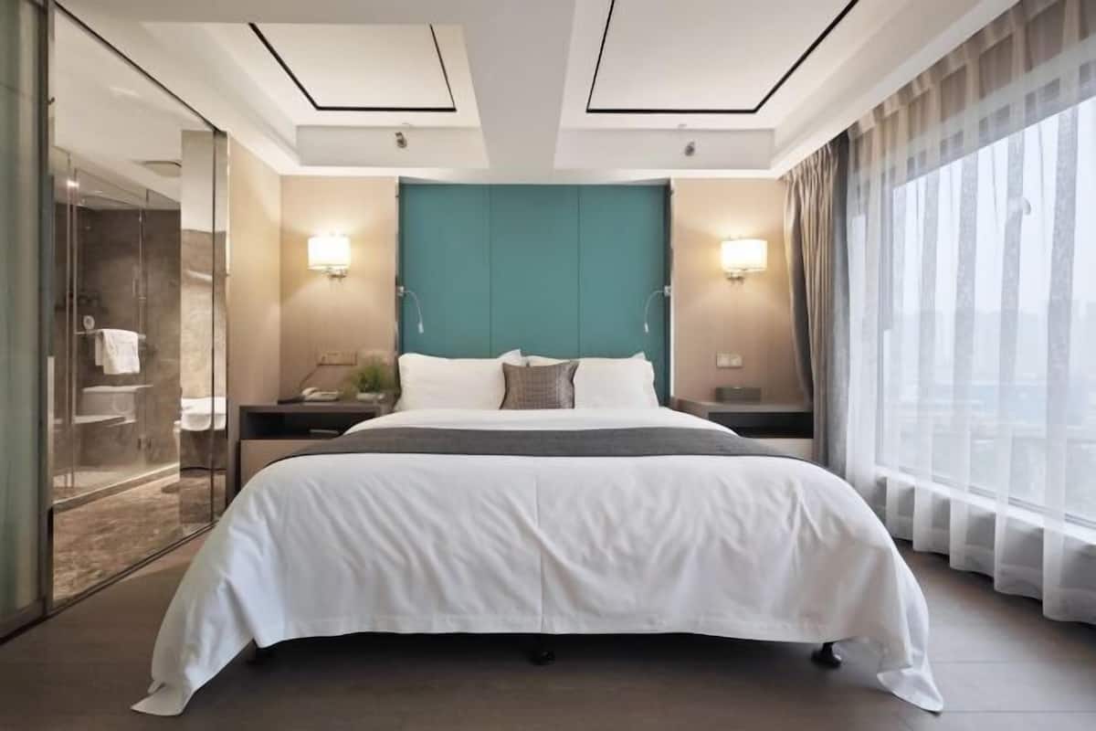 Premium bedding, desk, laptop workspace, blackout drapes