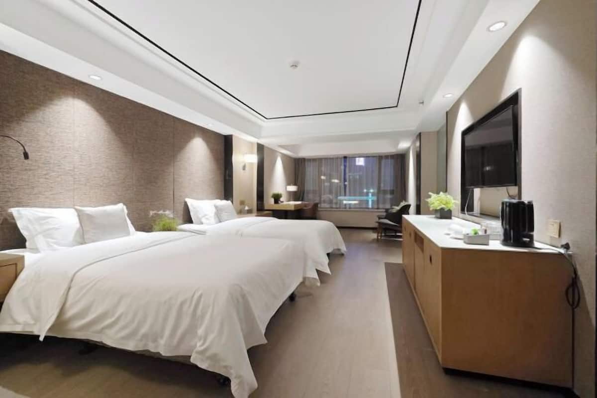 Premium bedding, desk, laptop workspace, blackout drapes