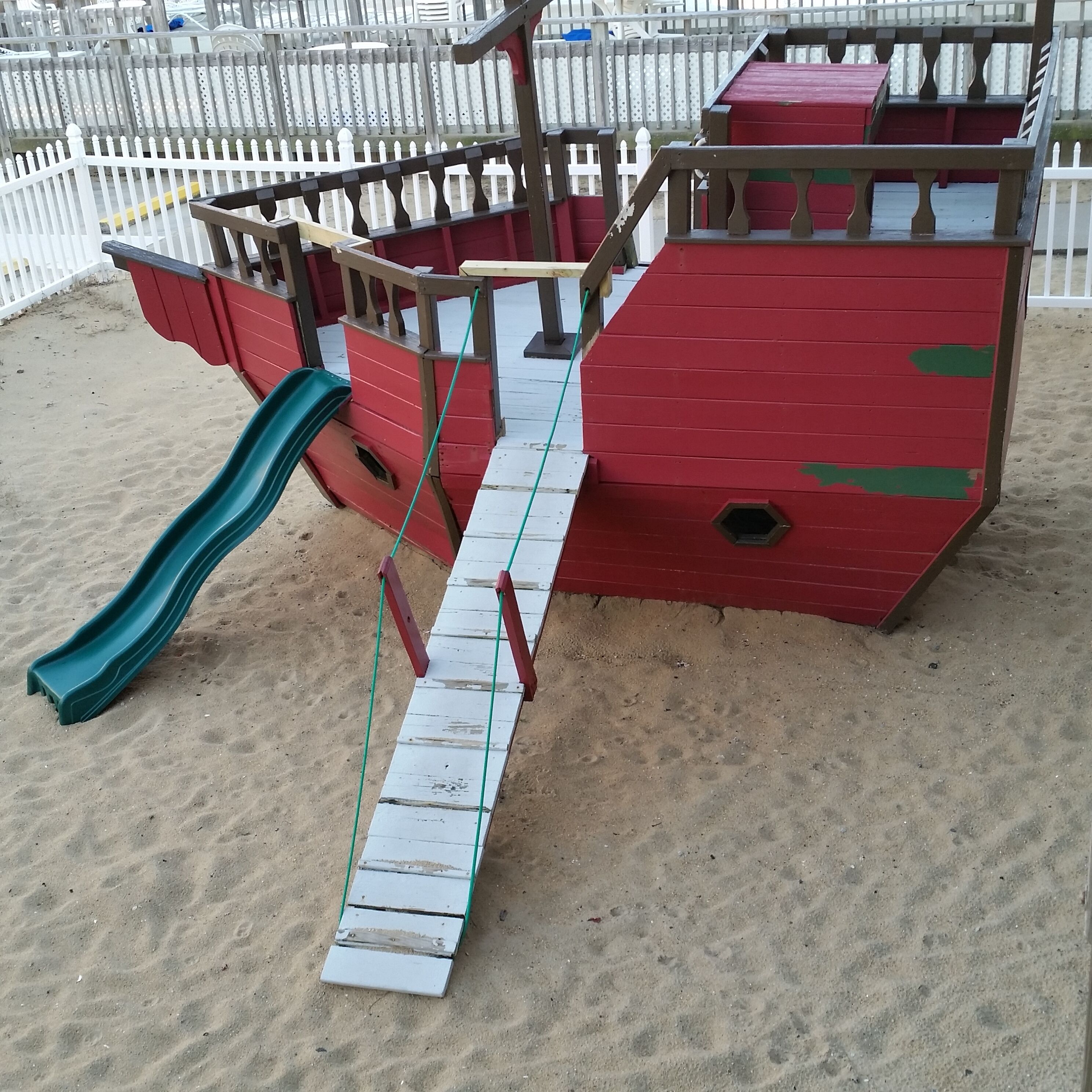 A playground with a slide and climbing structures.