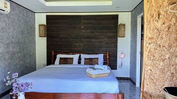 A bedroom with a wooden bed, a nightstand with a lamp, and a decorative vase.