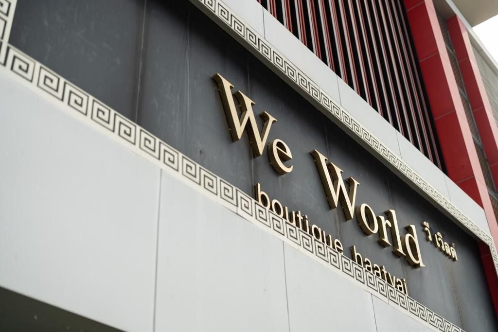 A building facade with the sign 'We World Boutique Hotel.'