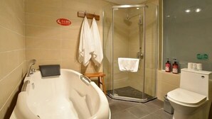 A bathroom with a bathtub, a shower, and a toilet.