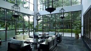 A spacious indoor area with large windows, modern furniture, and hanging lanterns. - International Asia-Pacific Convention Center (Sanya)