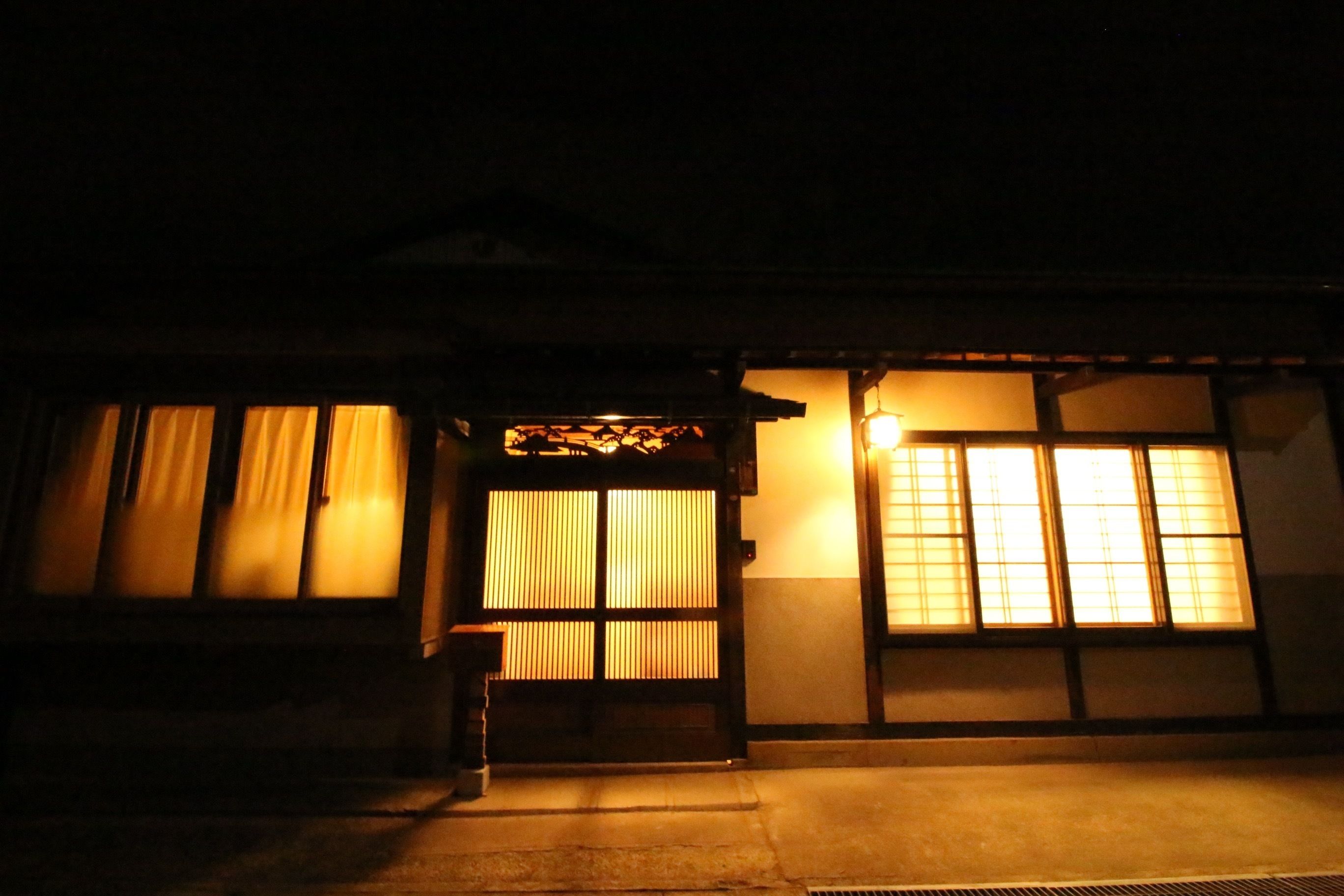 A traditional building with a wooden entrance and large windows.