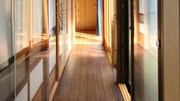 A corridor with wooden flooring and glass doors on both sides. - Hostel Fish In A River (Takayama)