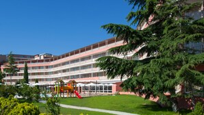 A multi-story hotel with a playground area in front. - Aronia Beach - All Incusive - All inclusive (Sunny Beach)