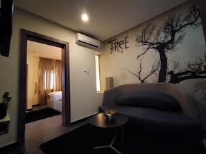 Junior Suite | Living room | 32-inch LCD TV with satellite channels, TV - Iris Hotel (Abuja)