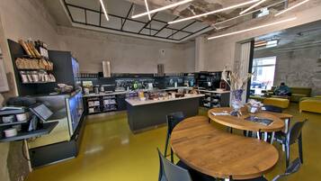 A modern kitchen with a central island, bar area, and seating.
