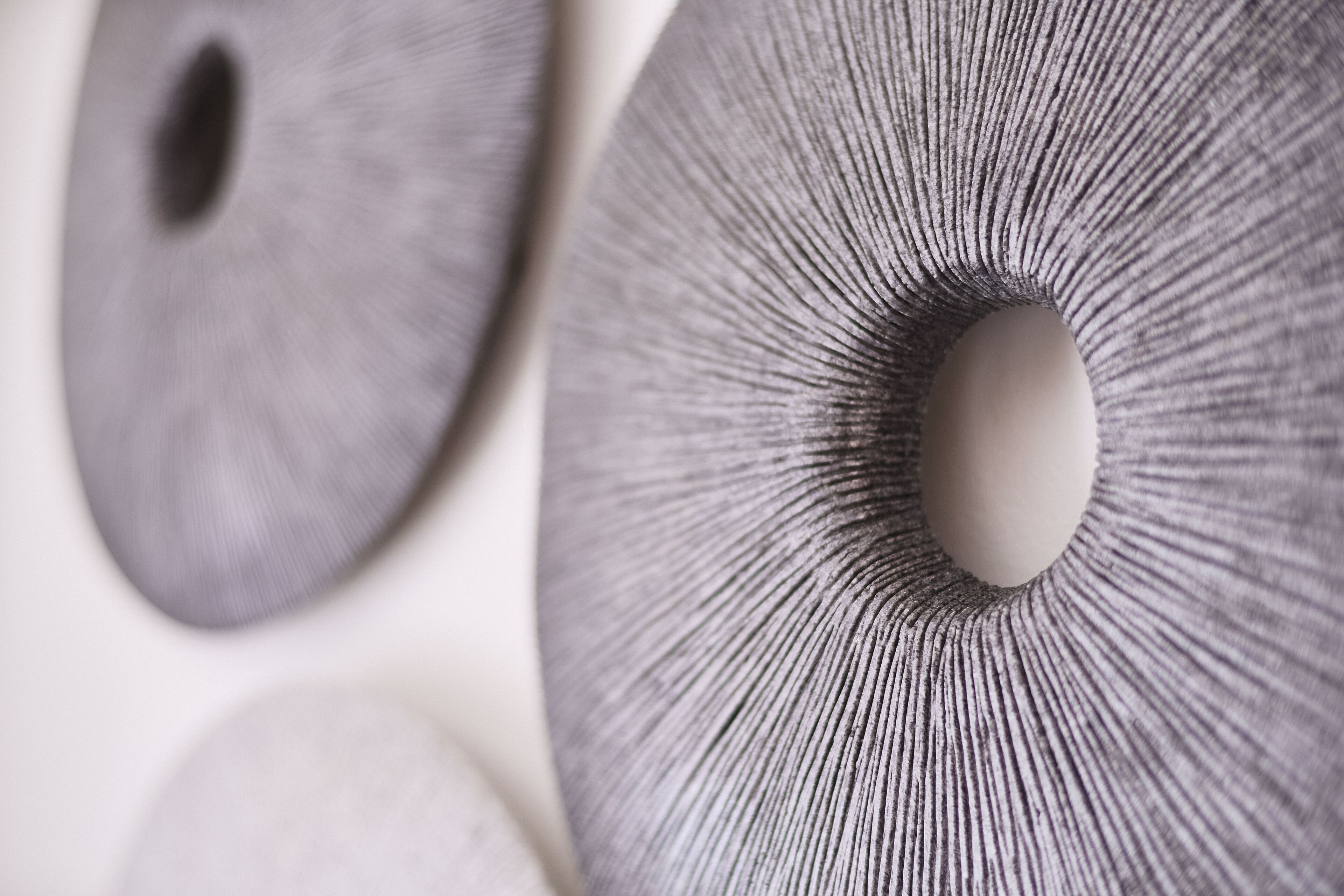 A close-up of a textured surface with a circular pattern and a central hole.