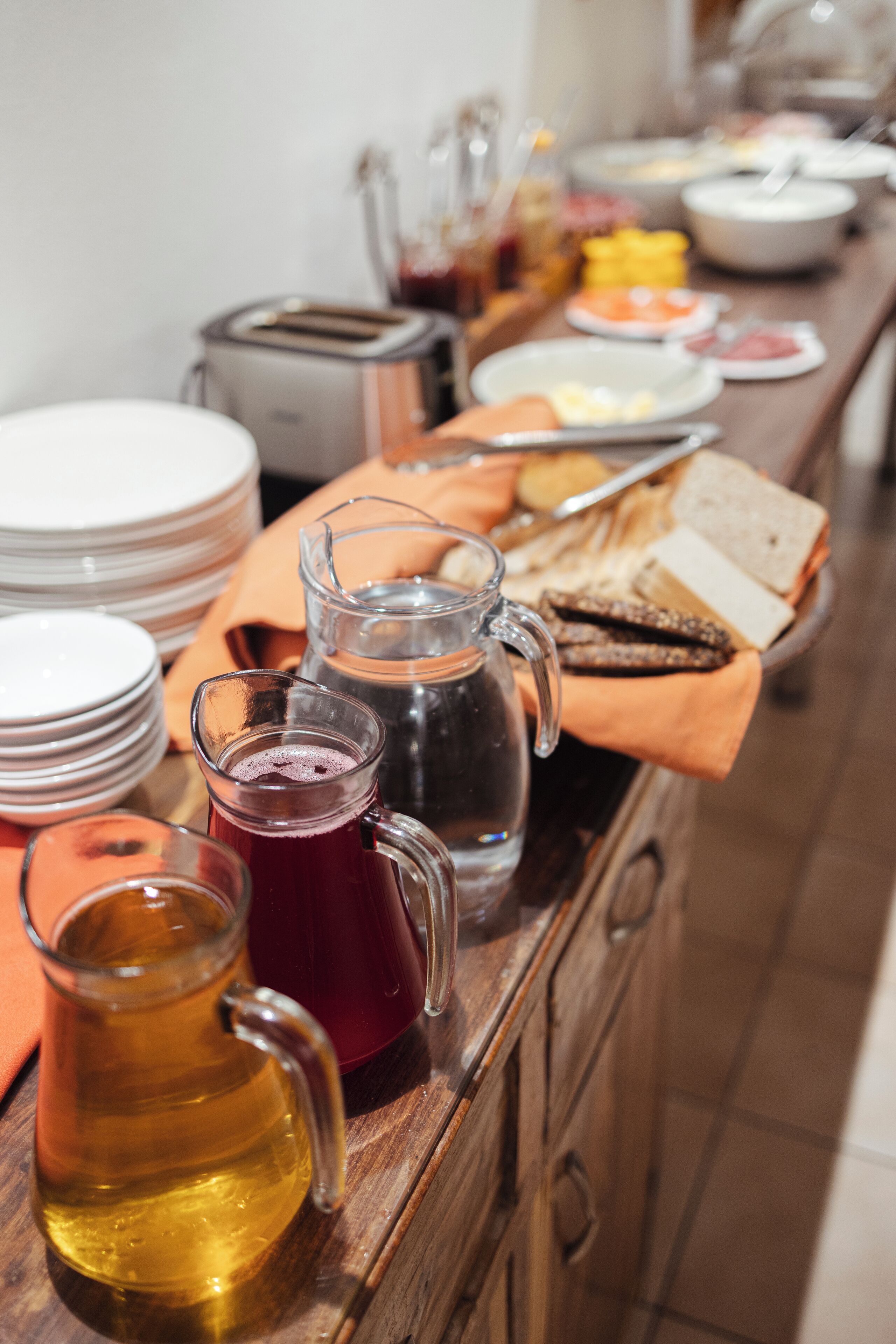 A buffet table with various food items and beverages.