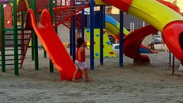 A playground with slides and climbing structures.