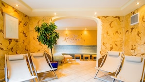 A spa area with reclining chairs, a large potted plant, and a 'Relax' sign on the wall. - Flattacher Hof (Flattach)