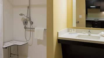 A bathroom with a shower, a sink, and a mirror.