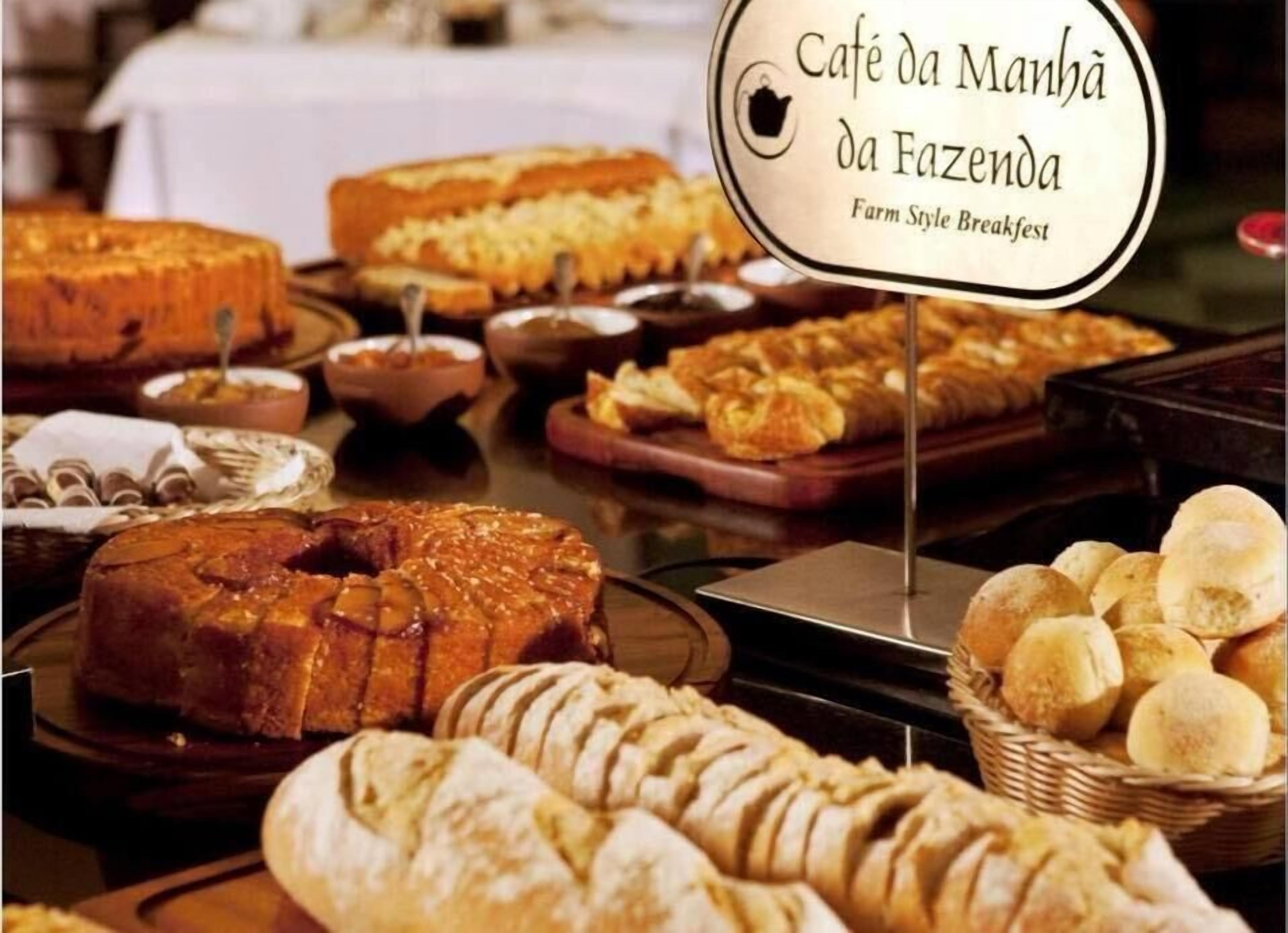 A breakfast buffet with various breads and pastries.