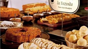 A breakfast buffet with various breads and pastries.