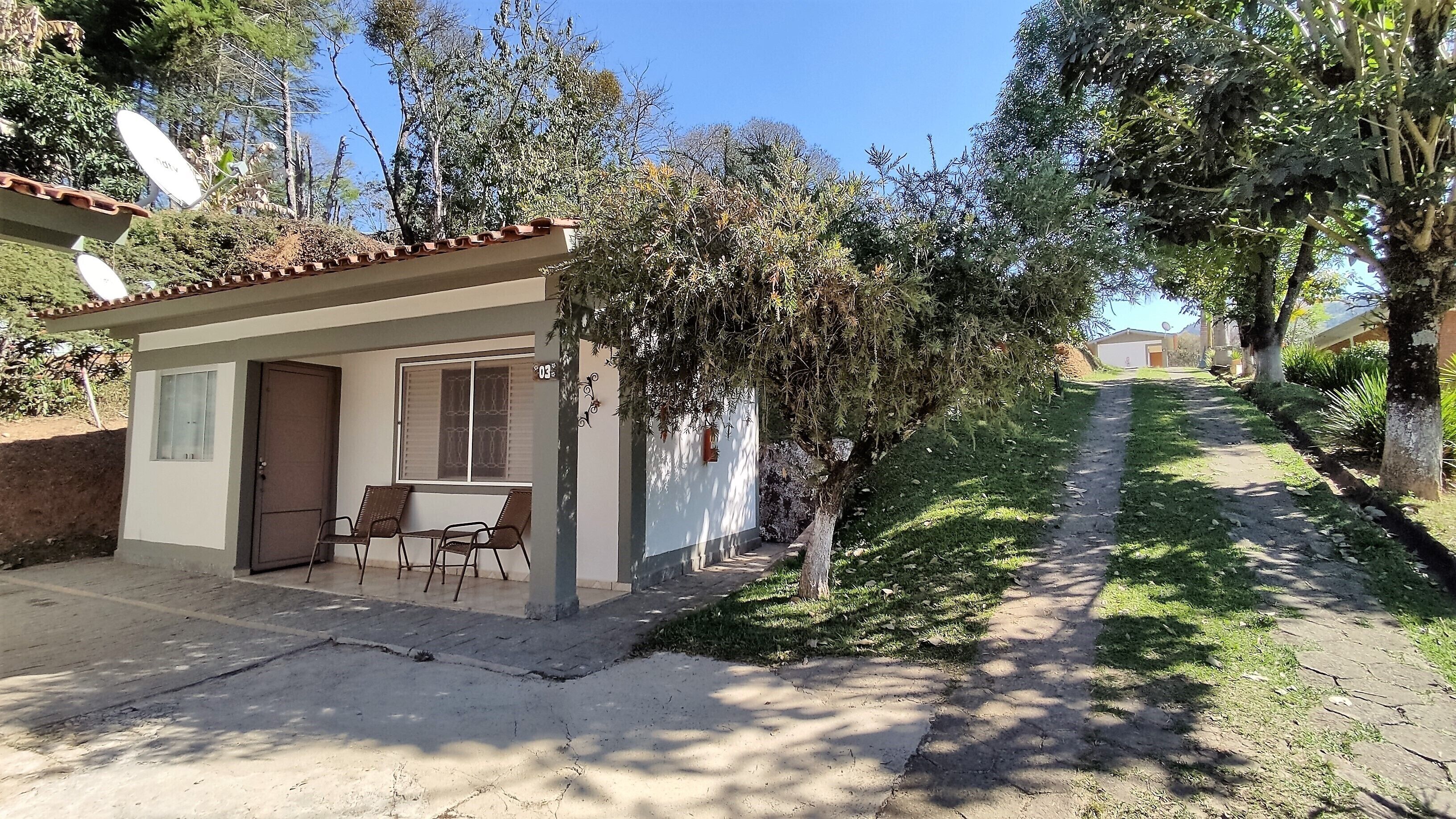 A small building with a patio area, a door, and a window.