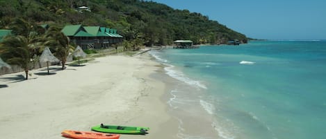 On the beach, white sand, sun-loungers, beach towels